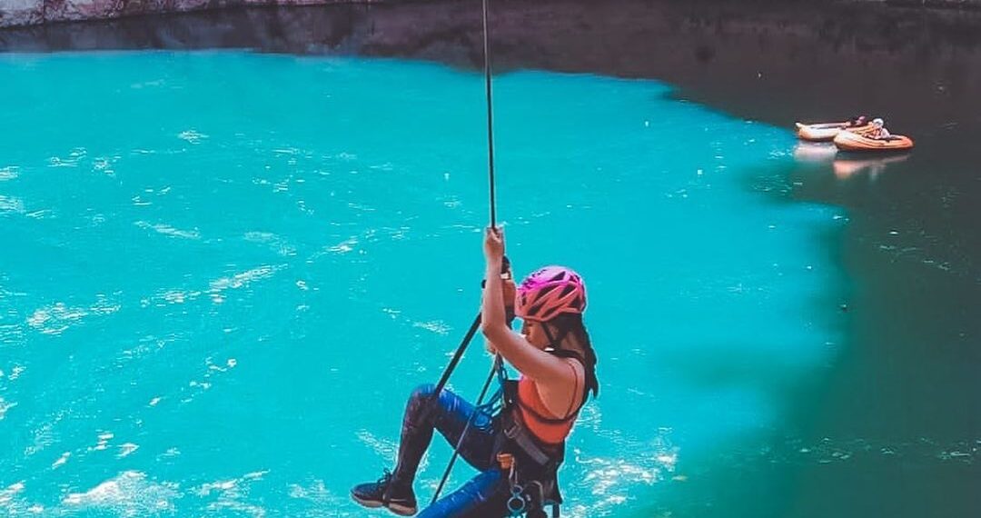 Mujer practicando rapel en el pozo del gavilán
